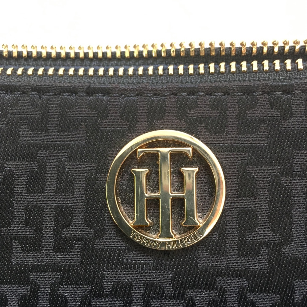 Classy Tommy Hilfiger black w/ gold trim crossbody purse w/open pocket in front.